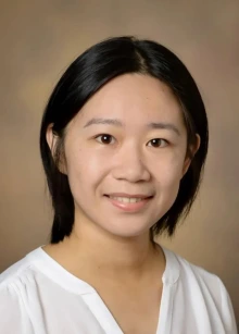 A person with black hair smiling